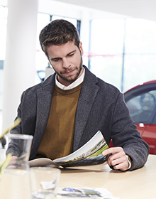 Customer viewing an assortment of key service offers in a dealership or brochure
